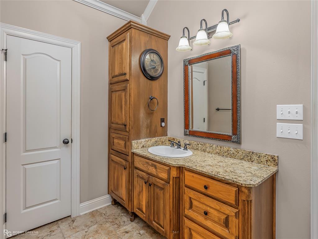 110 St Andrews Benton, LA 71006 - Photo 18 of 28 a bathroom with a granite countertop sink and a mirror