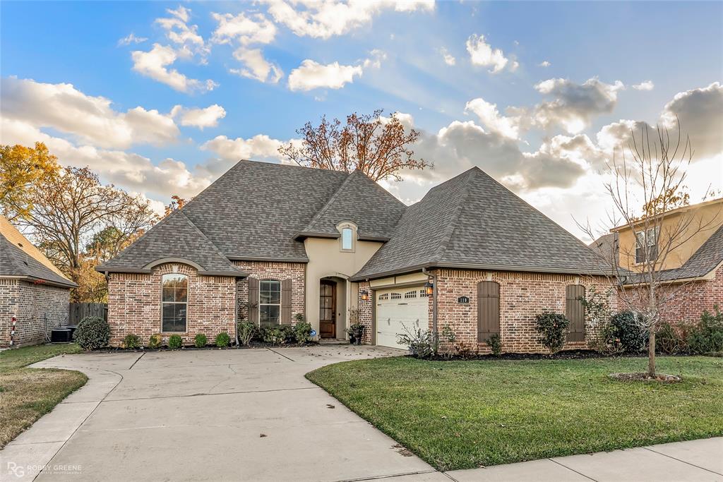 110 St Andrews Benton, LA 71006 - Photo 2 of 28 a front view of a house with a garden
