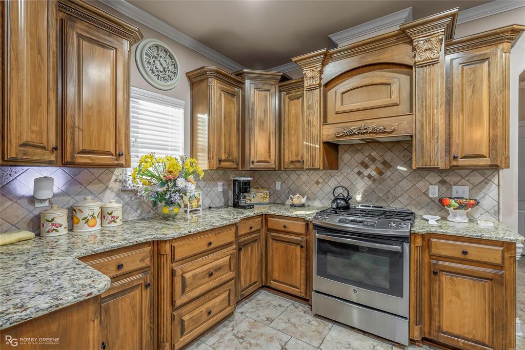 110 St Andrews Benton, LA 71006 - Photo 10 of 28 a kitchen with stainless steel appliances granite countertop a sink a stove and cabinets