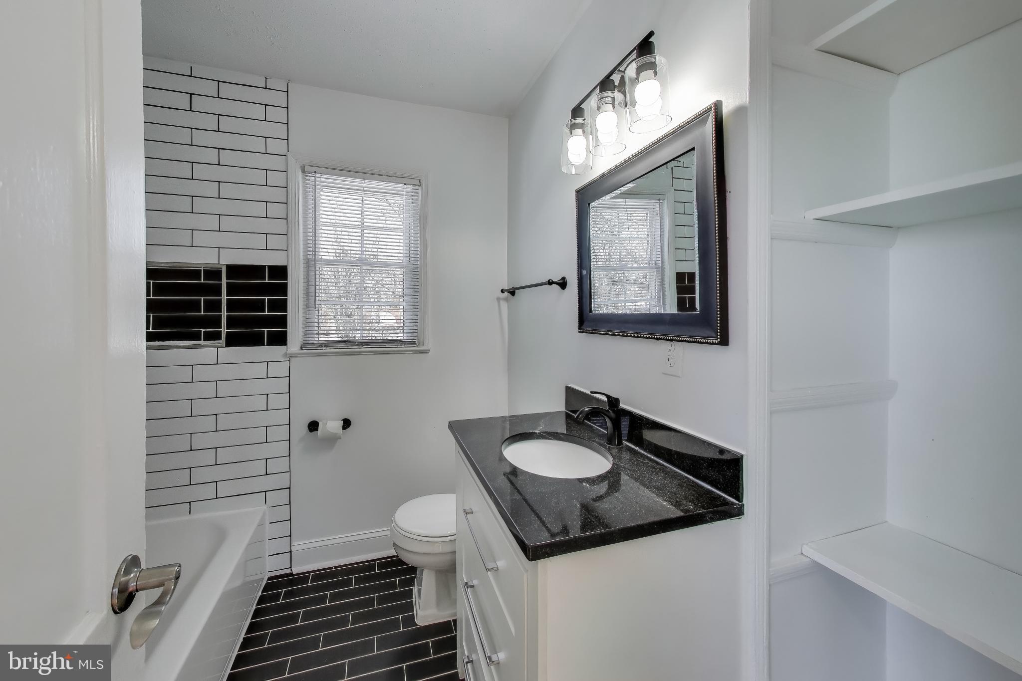 6904 Riggs Road Hyattsville, MD 20783 - Photo 12 of 34 a bathroom with a sink and a mirror