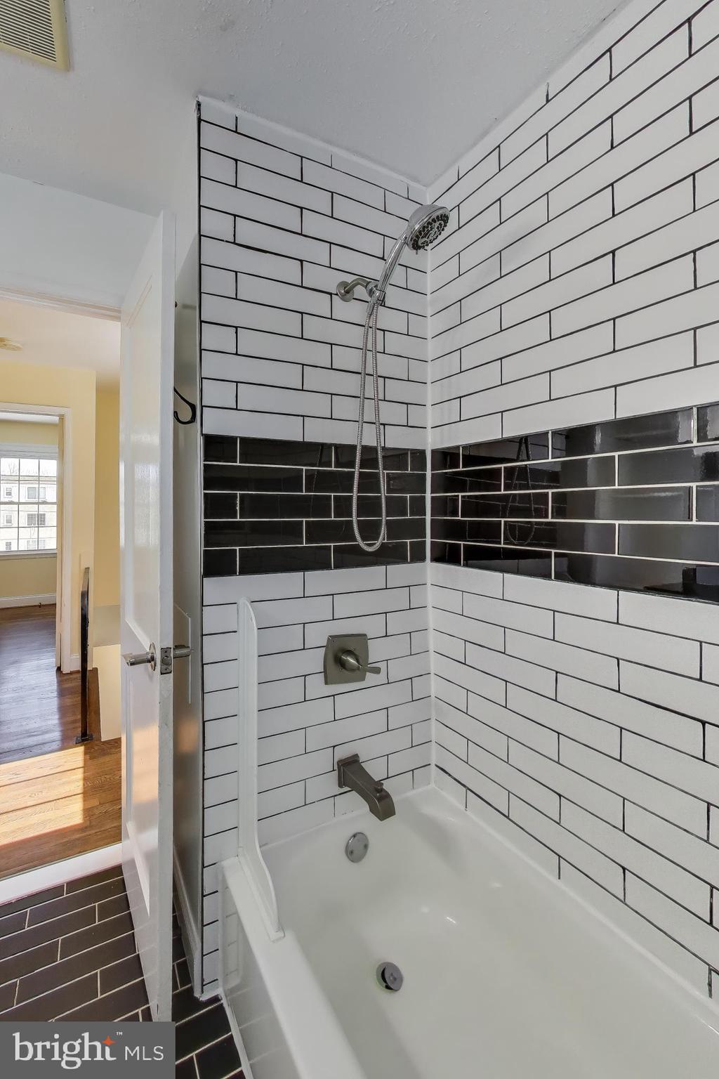 6904 Riggs Road Hyattsville, MD 20783 - Photo 13 of 34 a bathroom with a shower
