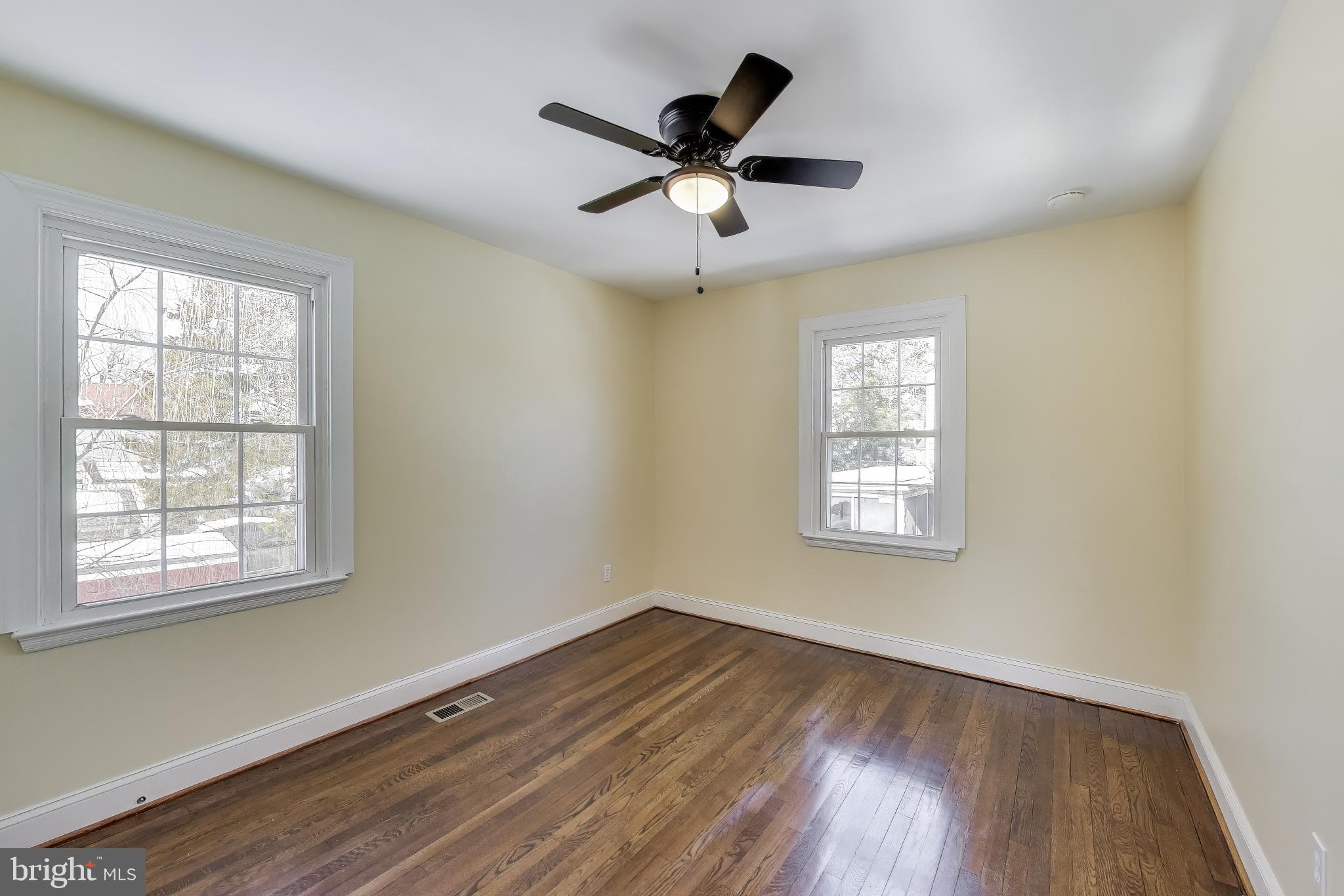 6904 Riggs Road Hyattsville, MD 20783 - Photo 14 of 34 a view of an empty room with wooden floor and a window