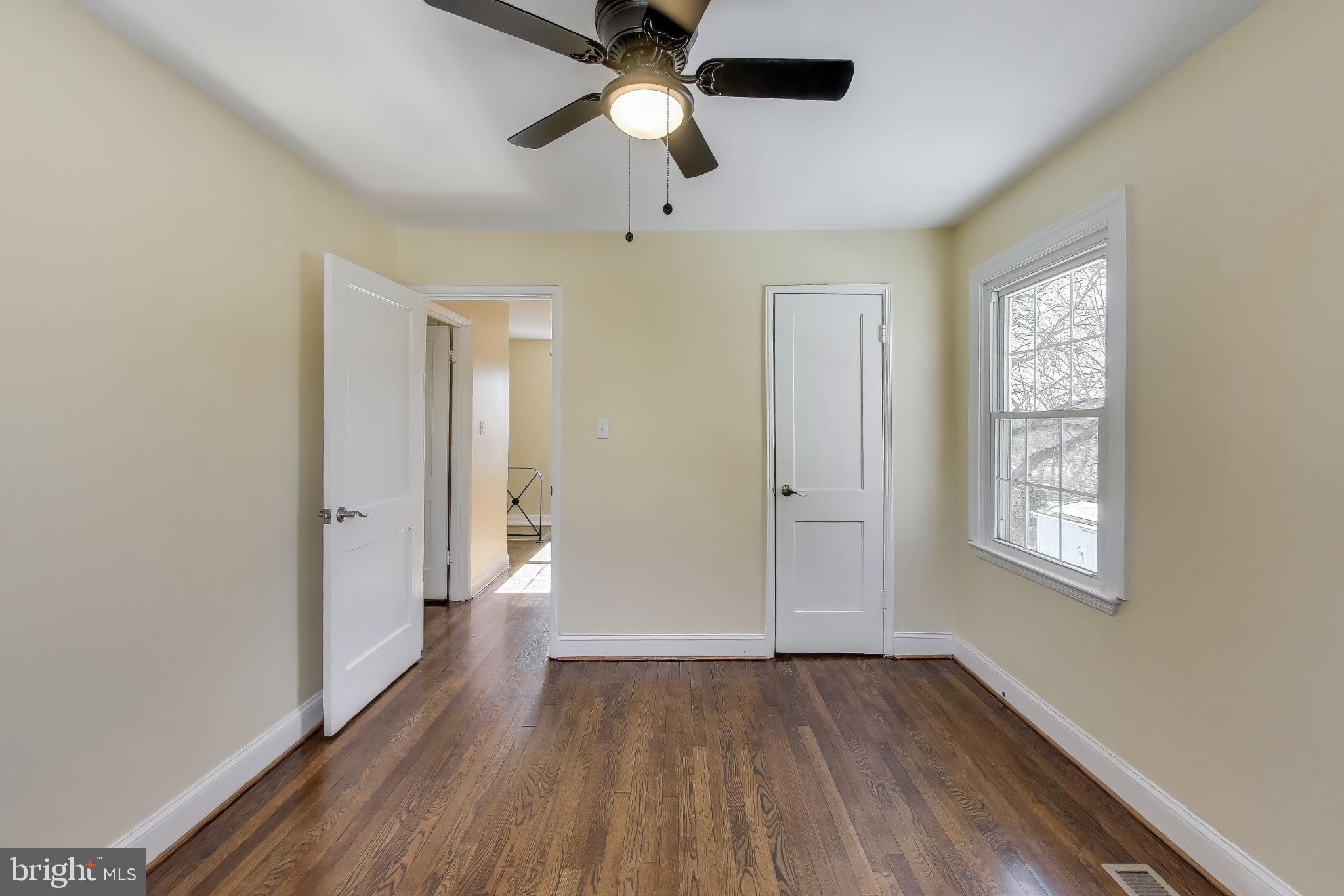 6904 Riggs Road Hyattsville, MD 20783 - Photo 15 of 34 a view of an empty room with a window and wooden floor