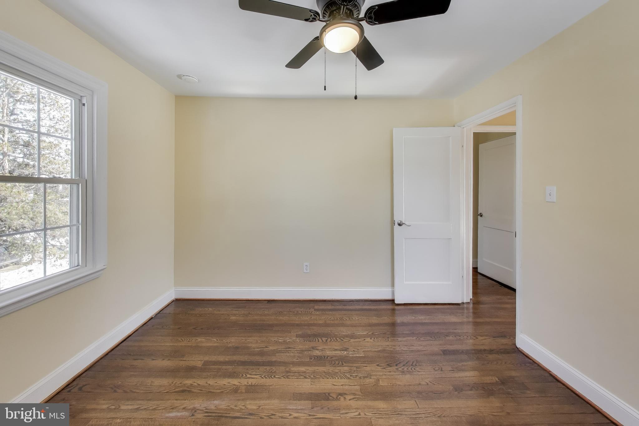 6904 Riggs Road Hyattsville, MD 20783 - Photo 16 of 34 wooden floor in an empty room with a window