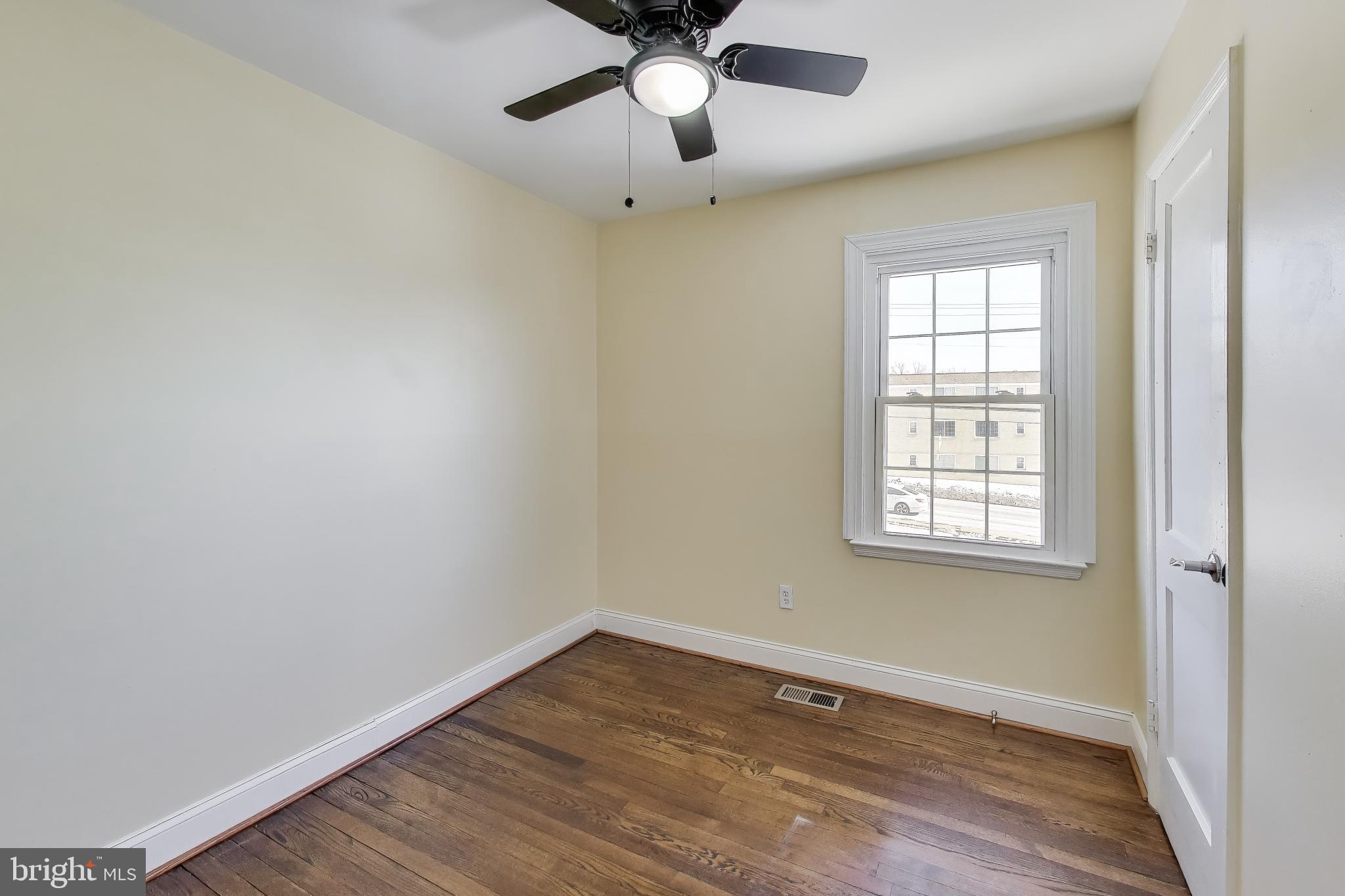 6904 Riggs Road Hyattsville, MD 20783 - Photo 18 of 34 a view of an empty room with wooden floor and a window