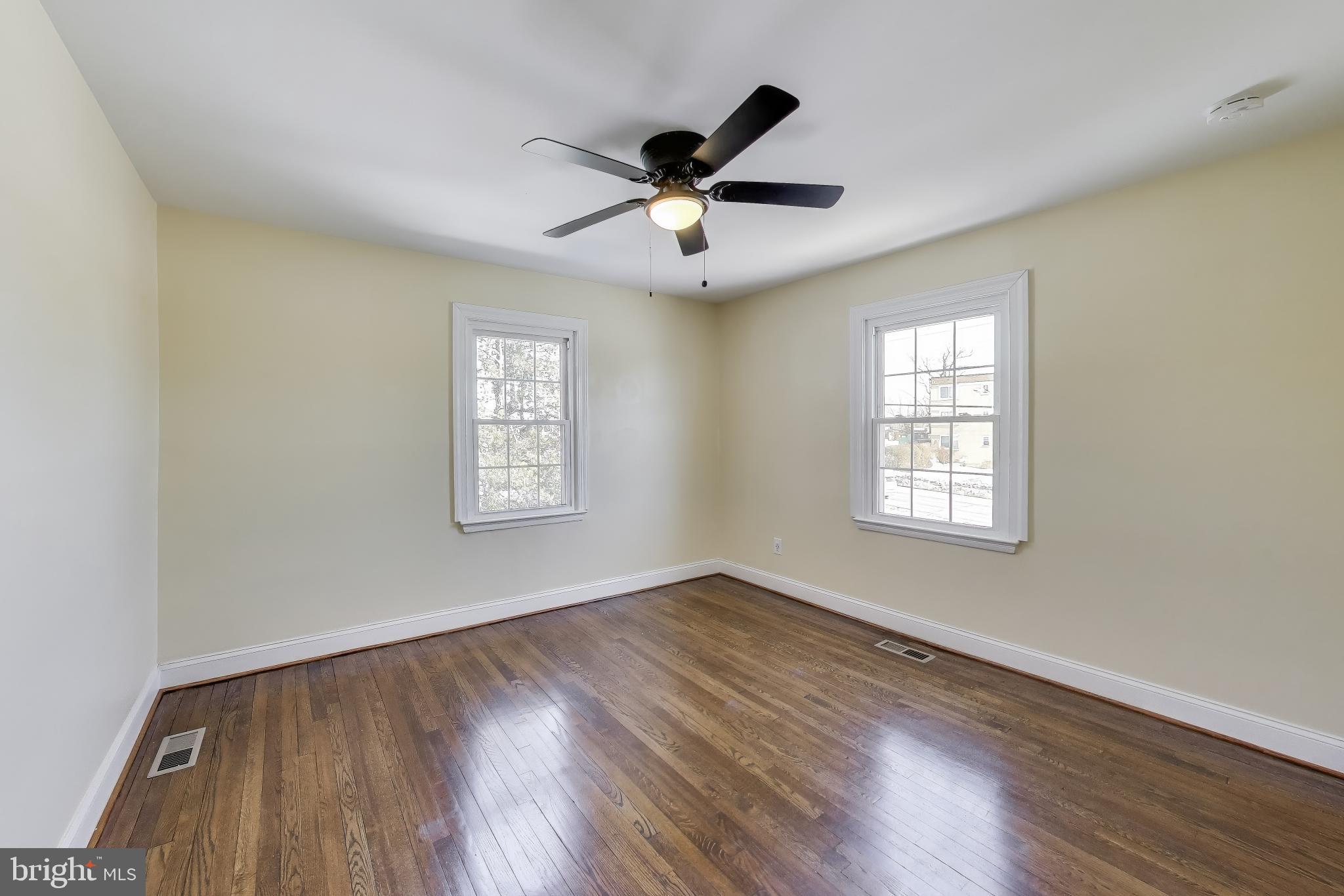 6904 Riggs Road Hyattsville, MD 20783 - Photo 21 of 34 a view of an empty room with wooden floor and a window