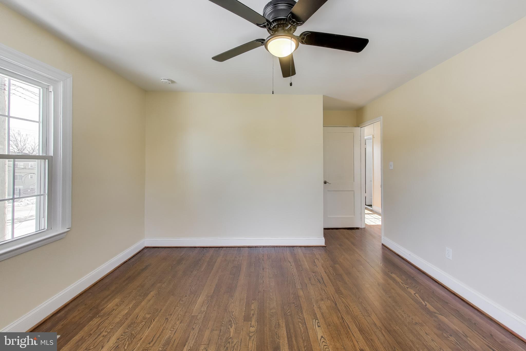 6904 Riggs Road Hyattsville, MD 20783 - Photo 22 of 34 wooden floor in an empty room with a window