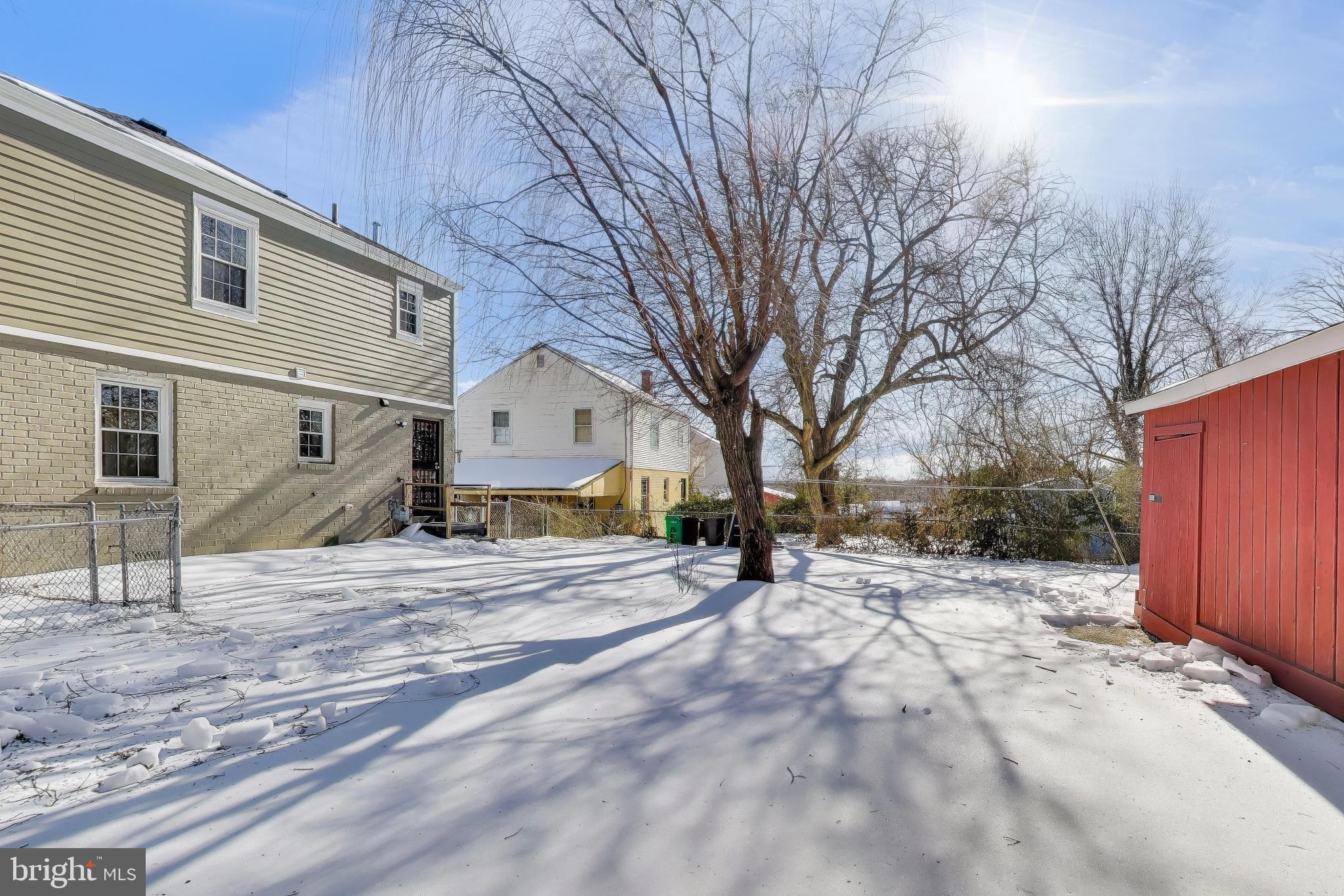 6904 Riggs Road Hyattsville, MD 20783 - Photo 25 of 34 a view of a house with a yard covered in snow