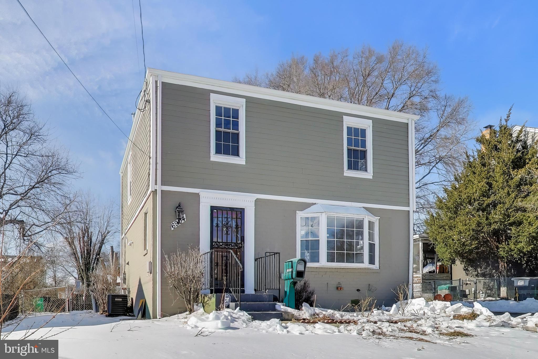 6904 Riggs Road Hyattsville, MD 20783 - Photo 32 of 34 a front view of a house with a yard