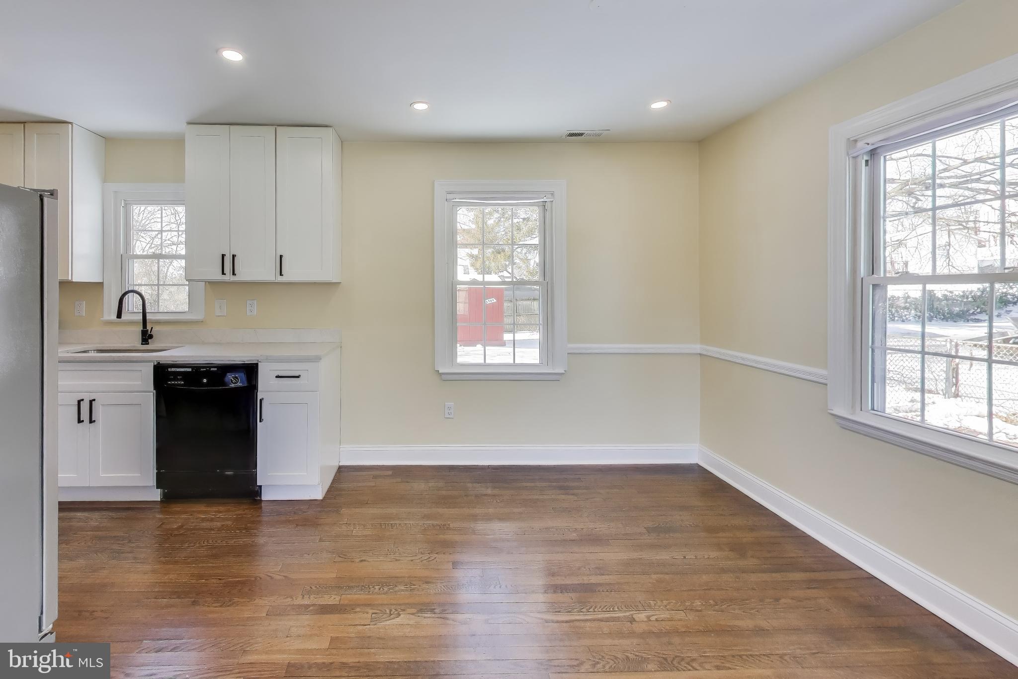 6904 Riggs Road Hyattsville, MD 20783 - Photo 8 of 34 an empty room with wooden floor and windows