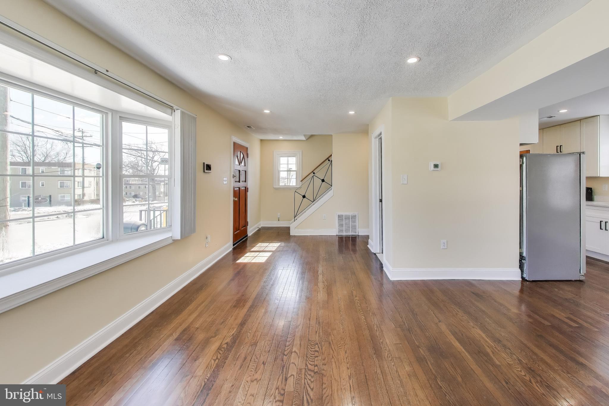 6904 Riggs Road Hyattsville, MD 20783 - Photo 9 of 34 a view of empty room with wooden floor and electronic appliances