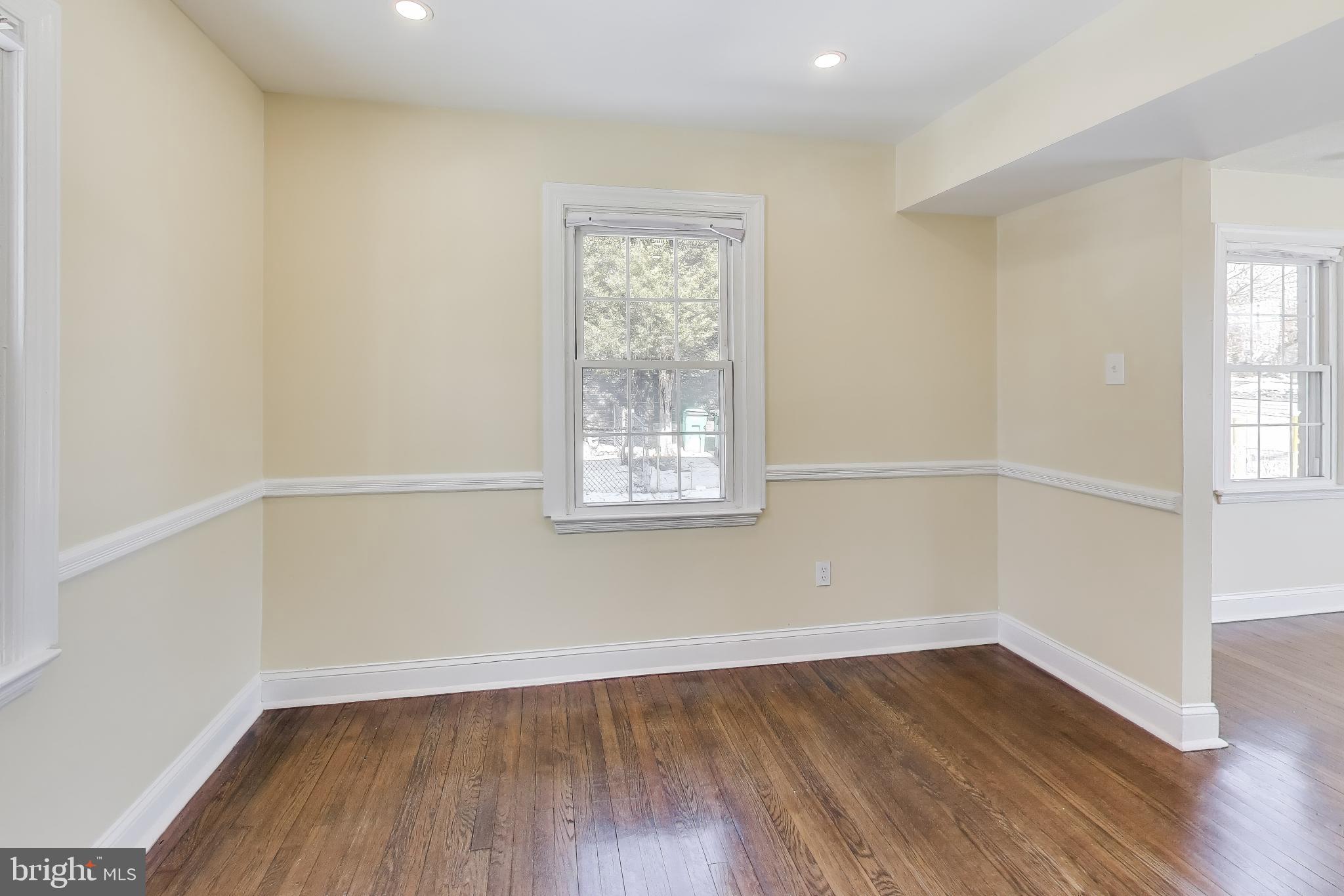 6904 Riggs Road Hyattsville, MD 20783 - Photo 10 of 34 an empty room with wooden floor and windows