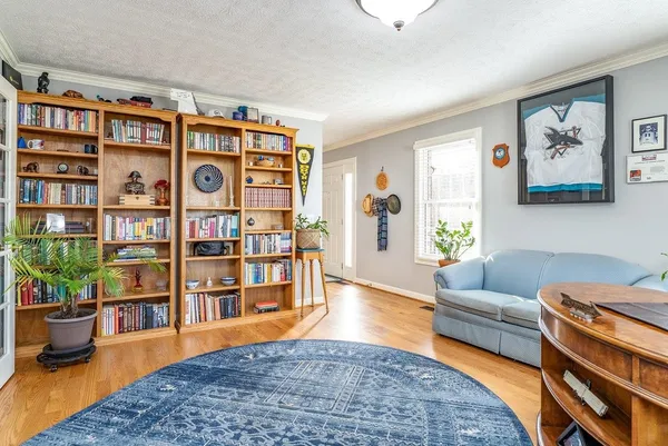 a bedroom with a bed a chandelier and a book shelf