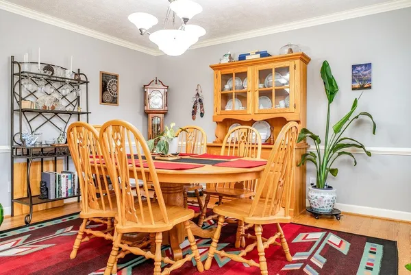 a view of a dining room with furniture window and wooden floor