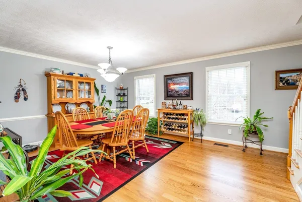 a view of a dining room with furniture and wooden floor