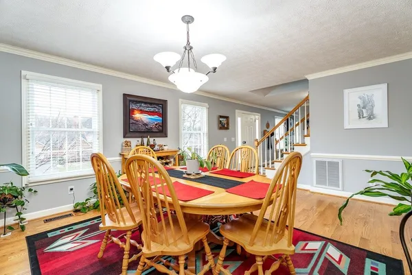 a kitchen with a table chairs refrigerator and cabinets