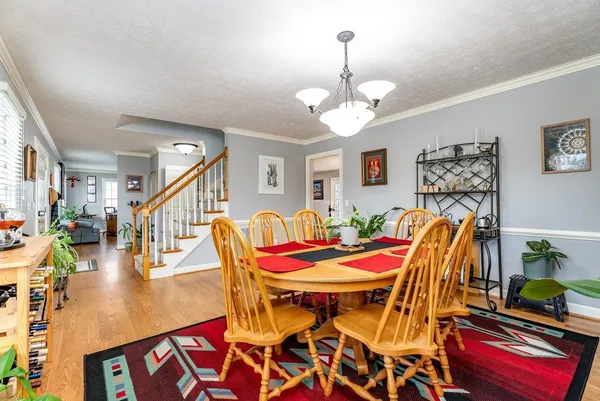 a kitchen with stainless steel appliances granite countertop a sink dishwasher stove and cabinets with wooden floor