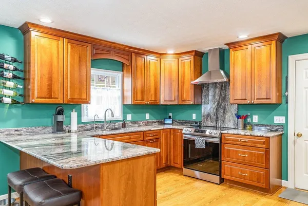 a kitchen with stainless steel appliances granite countertop sink stove and cabinets