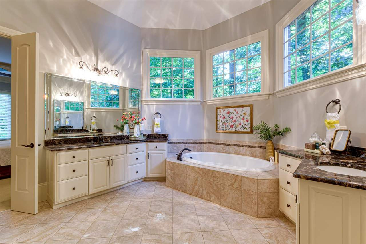 1317 Caistor Lane Raleigh, NC 27614 - Photo 11 of 24 This is the main level owners bath, dual vanity, gorgeous tile work and a huge WALK-IN closet. The walk-in shower glass replacement has been ordered & will be installed shorty. Owners Bath x2