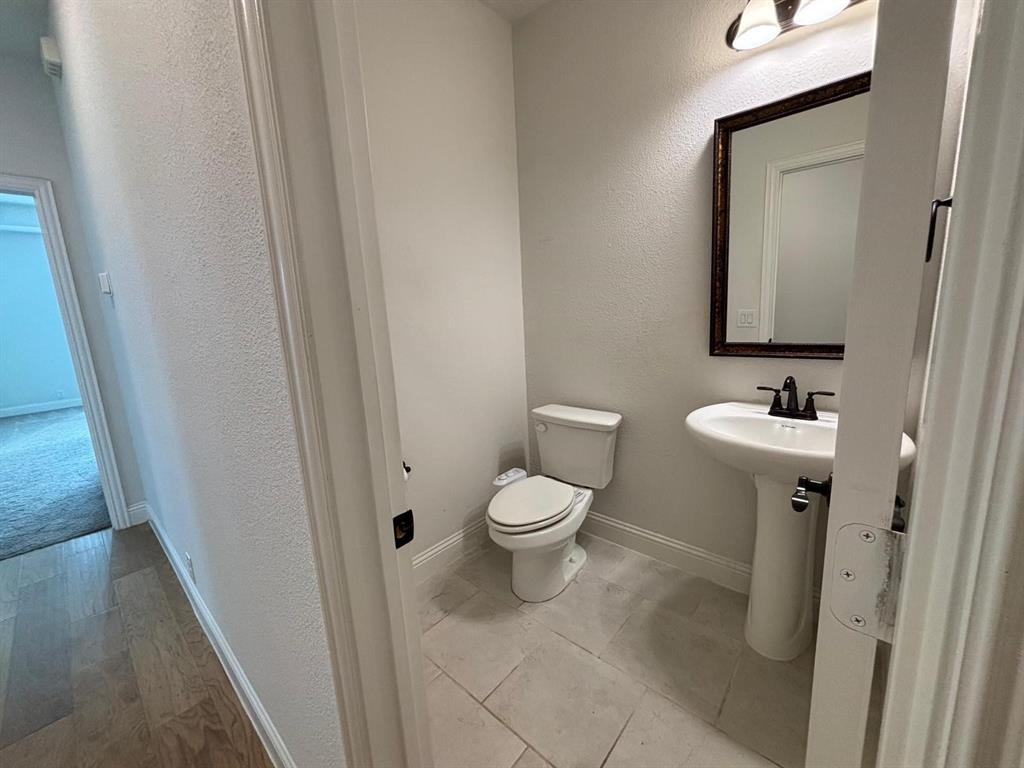 1080 Canuela Way Justin, TX 76247 - Photo 13 of 30 a bathroom with a toilet sink and mirror