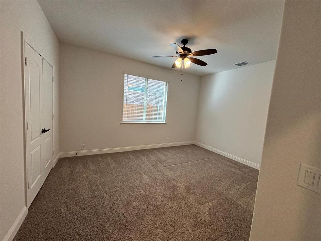 1080 Canuela Way Justin, TX 76247 - Photo 16 of 30 an empty room with windows and fan