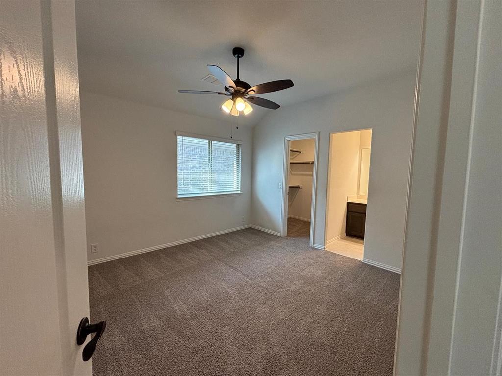 1080 Canuela Way Justin, TX 76247 - Photo 17 of 30 an empty room with windows and fan