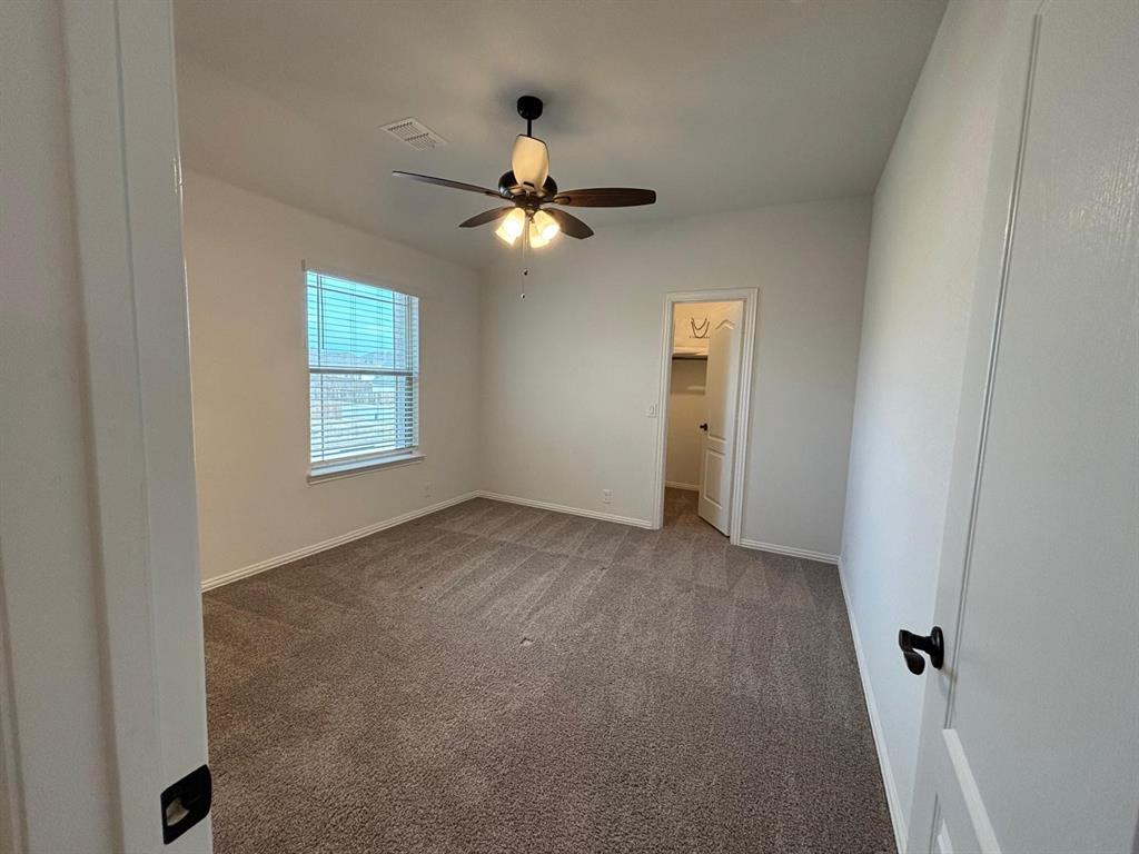 1080 Canuela Way Justin, TX 76247 - Photo 18 of 30 an empty room with windows and fan