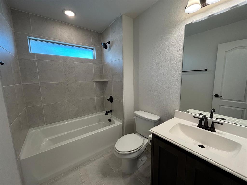 1080 Canuela Way Justin, TX 76247 - Photo 20 of 30 a bathroom with a sink toilet and shower