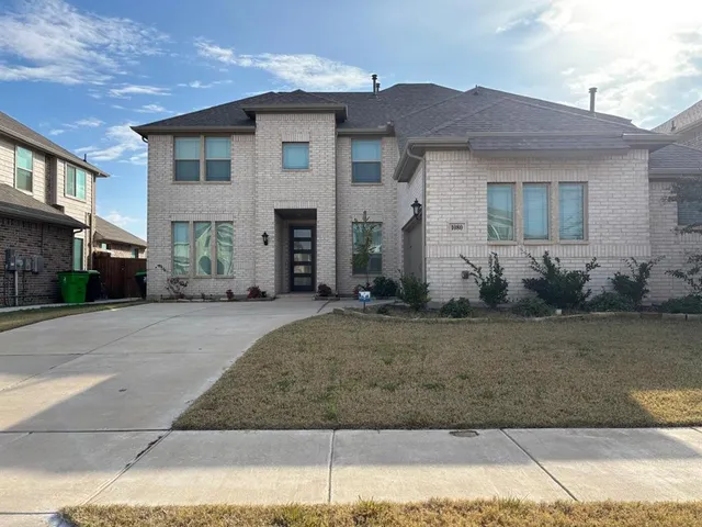a kitchen with granite countertop wooden cabinets a sink and dishwasher