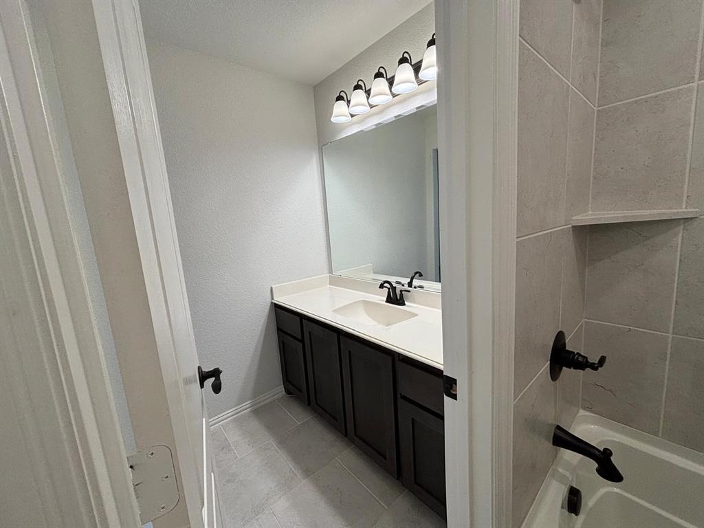 1080 Canuela Way Justin, TX 76247 - Photo 21 of 30 a bathroom with a double vanity sink and mirror