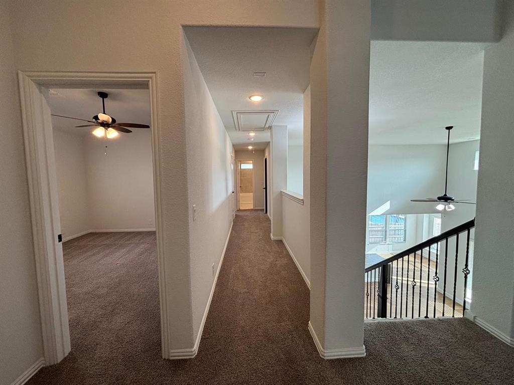 1080 Canuela Way Justin, TX 76247 - Photo 22 of 30 a view of a hallway with wooden floor and a bathroom