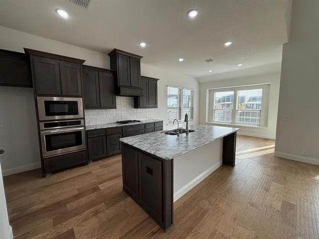 a view of a kitchen with a sink and cabinets