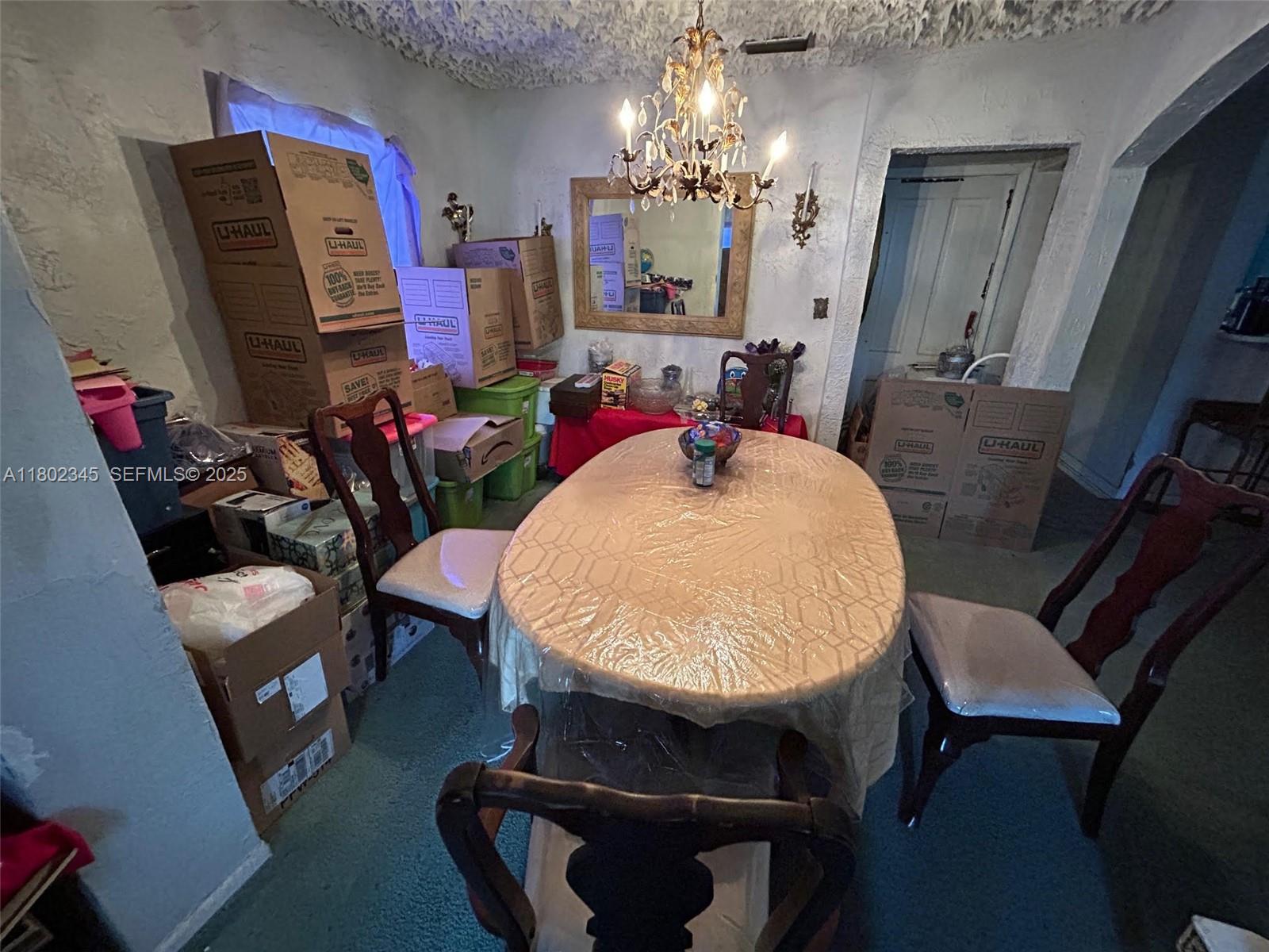 10354 Southwest 173rd Street Miami, FL 33157 - Photo 11 of 12 a room with furniture and a chandelier