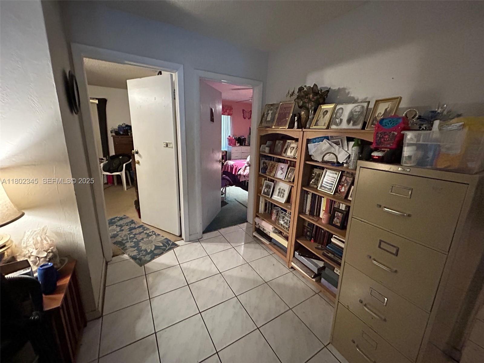 10354 Southwest 173rd Street Miami, FL 33157 - Photo 12 of 12 a view of walk in closet with clothes and shoes