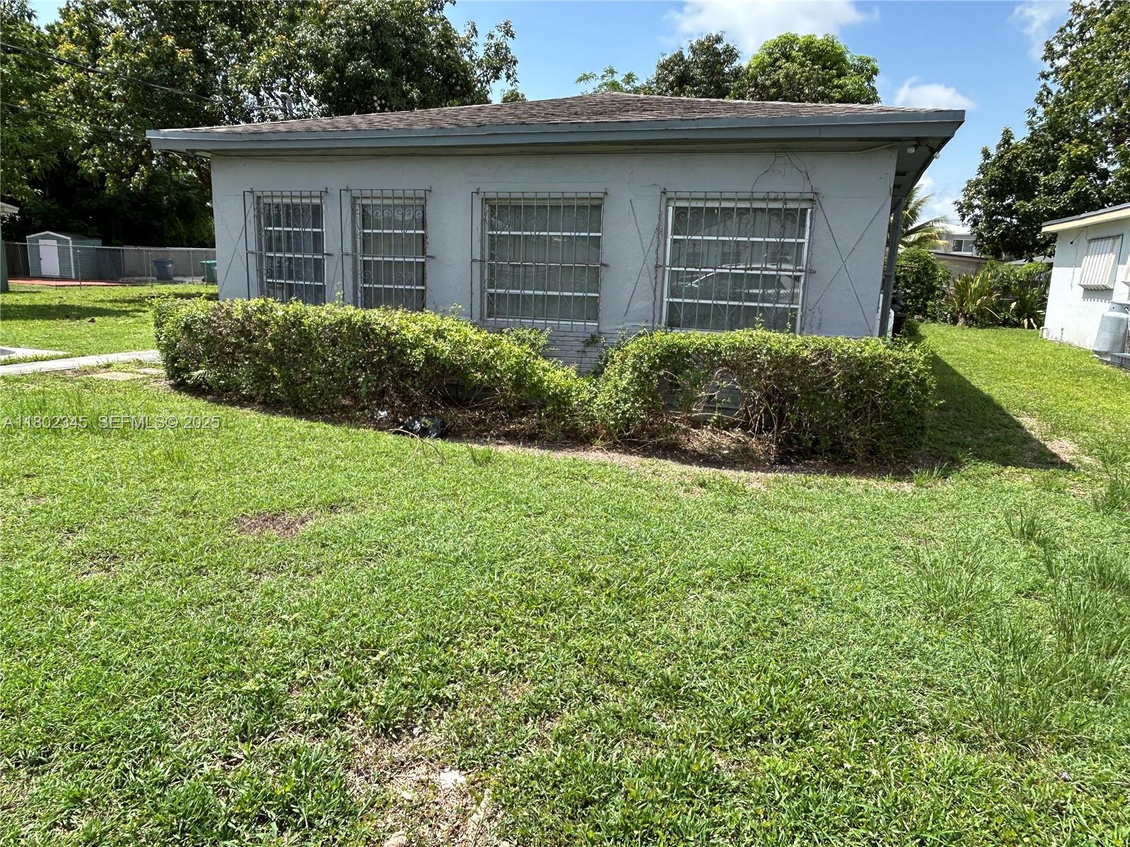 10354 Southwest 173rd Street Miami, FL 33157 - Photo 2 of 12 a view of a house with a yard and plants