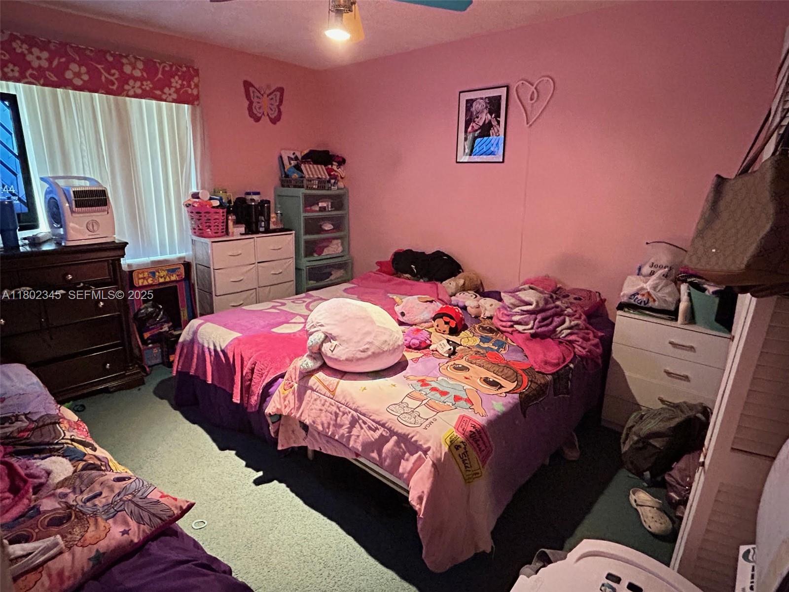 10354 Southwest 173rd Street Miami, FL 33157 - Photo 4 of 12 a bedroom with a bed and a mirror