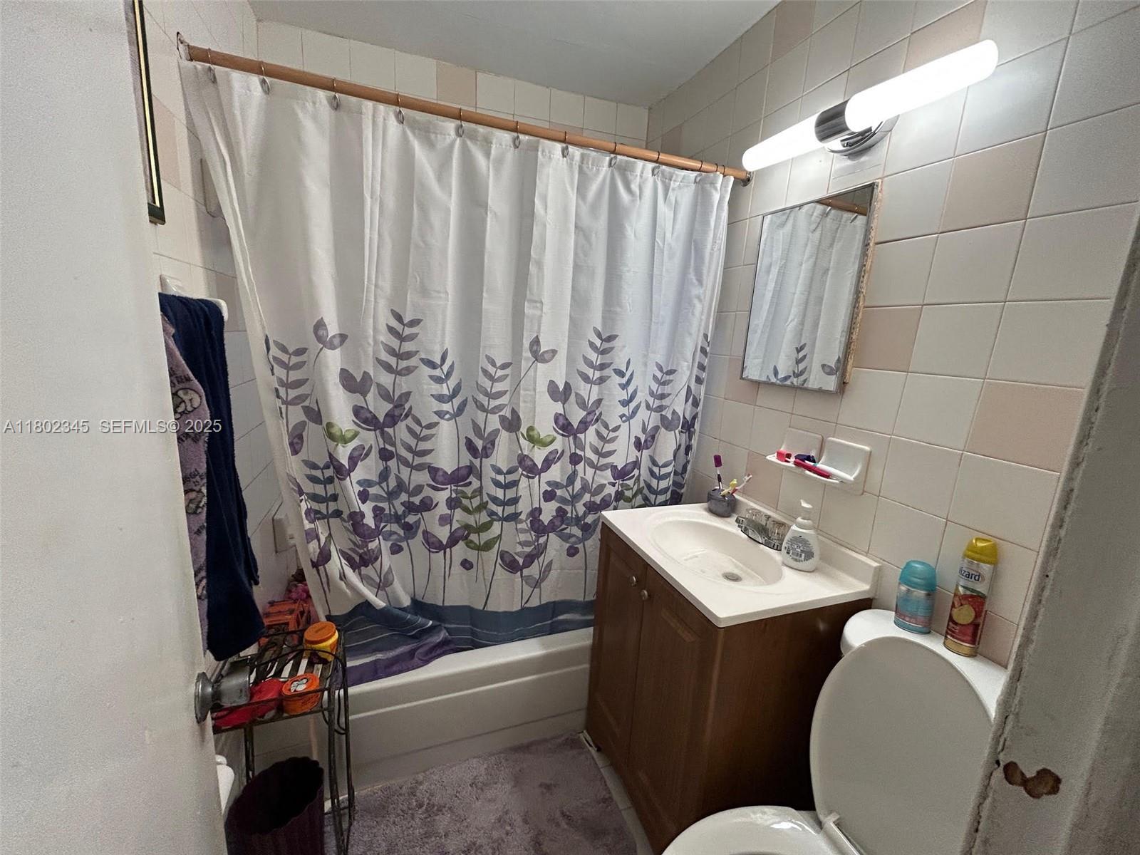 10354 Southwest 173rd Street Miami, FL 33157 - Photo 6 of 12 a bathroom with a sink toilet and tub