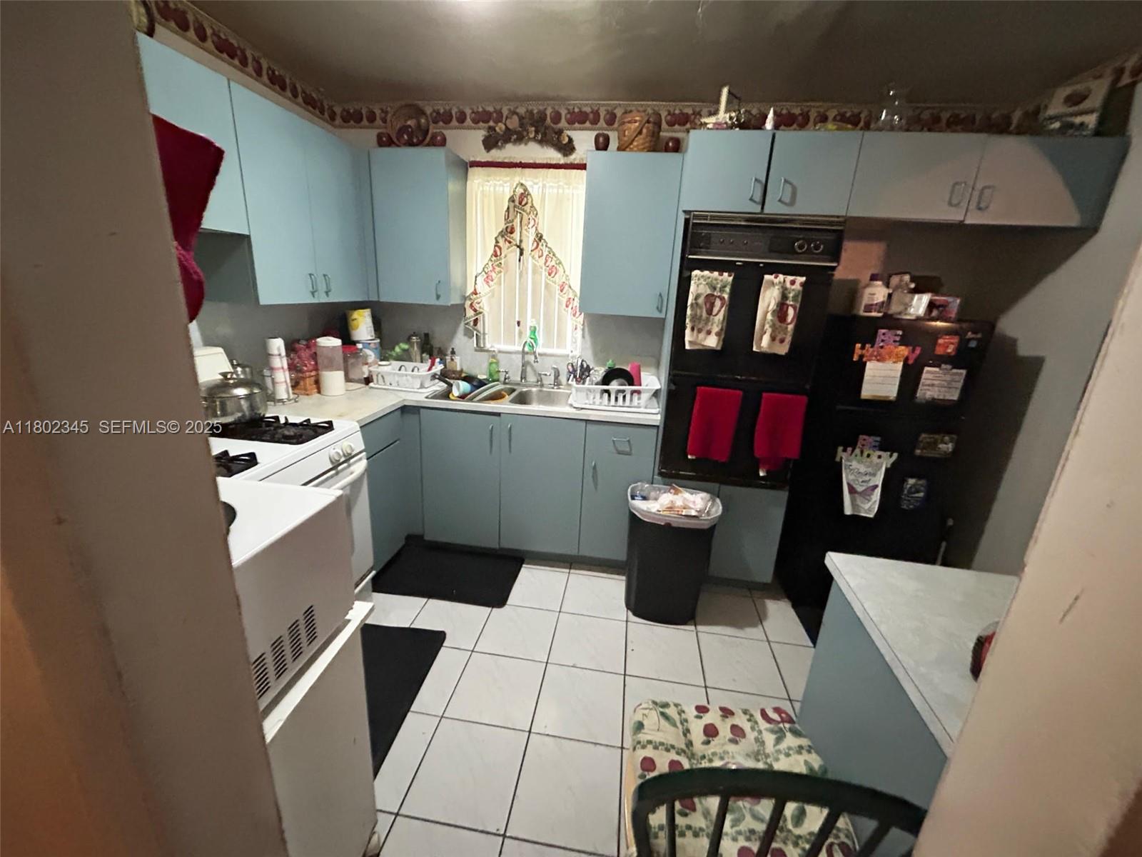 10354 Southwest 173rd Street Miami, FL 33157 - Photo 9 of 12 a kitchen with a sink and cabinets