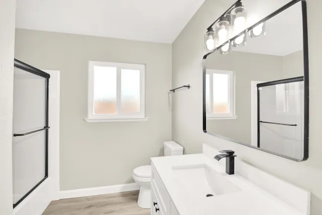 a bathroom with a sink toilet and shower