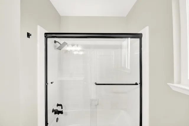a bathroom with a glass shower door