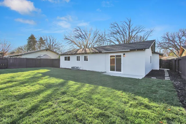 a front view of house with yard and trees