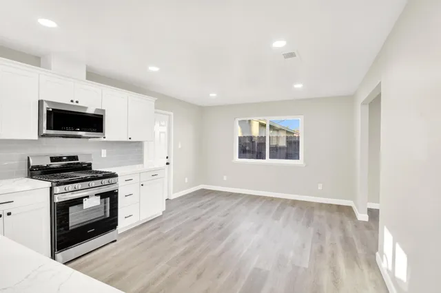 a kitchen with a stove a sink and a microwave