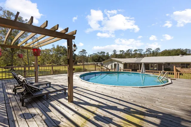 a view of balcony with wooden floor and outdoor seating