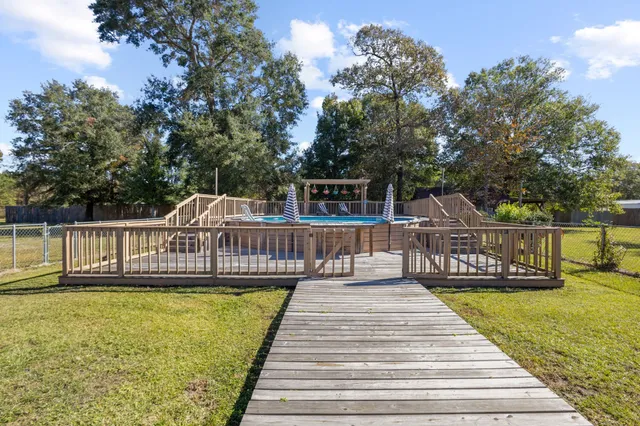 a view of balcony with wooden floor and fence