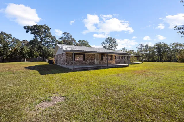 a view of a house with swimming pool and yard