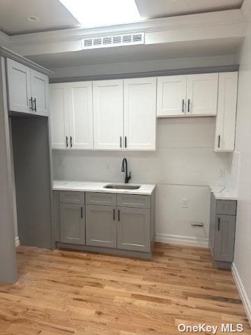 a view of a kitchen with sink and cabinets