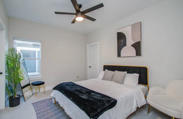 a bedroom with a bed and a potted plant