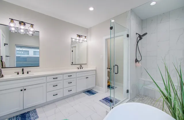 a bathroom with a double vanity sink a mirror and a shower