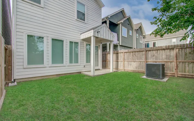 a view of a house with a yard and sitting area