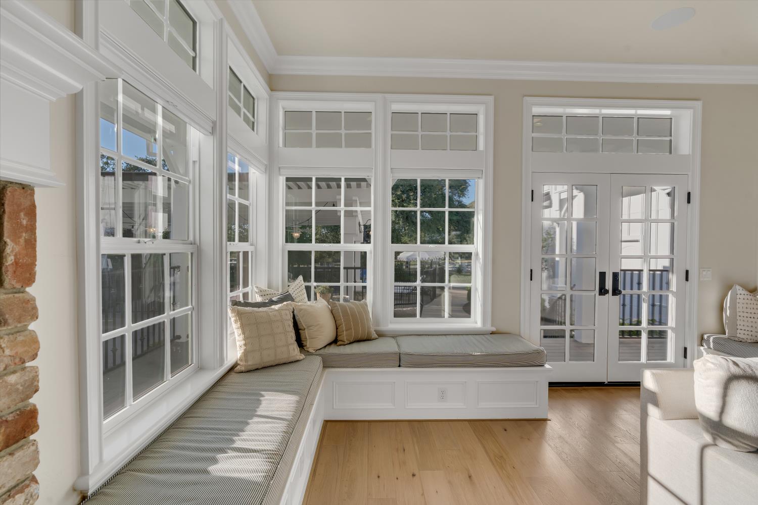 2905 Virginiatown Road Lincoln, CA 95648 - Photo 18 of 86 Window-lined room featuring a built-in window seat, French doors, hardwood flooring, and a brick-clad architectural element